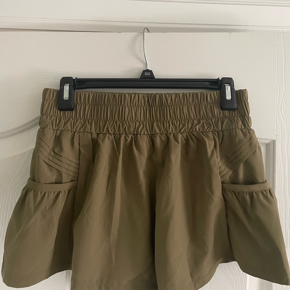 Army green flowy athletic shorts with pockets